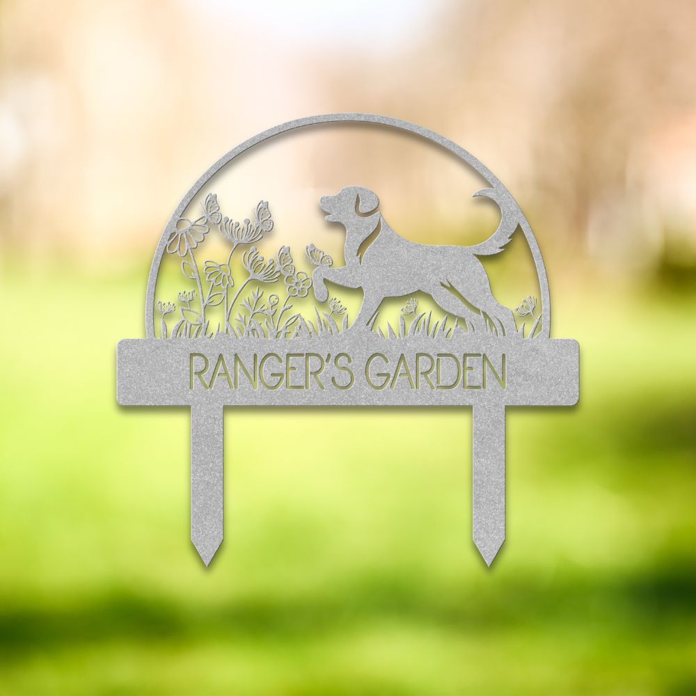 Custom metal dog garden stake featuring a playful Labrador-style silhouette surrounded by wildflowers and butterflies. Personalized outdoor yard sign with “RANGER'S GARDEN” cutout text – perfect pet memorial or dog lover gift for garden decor.
