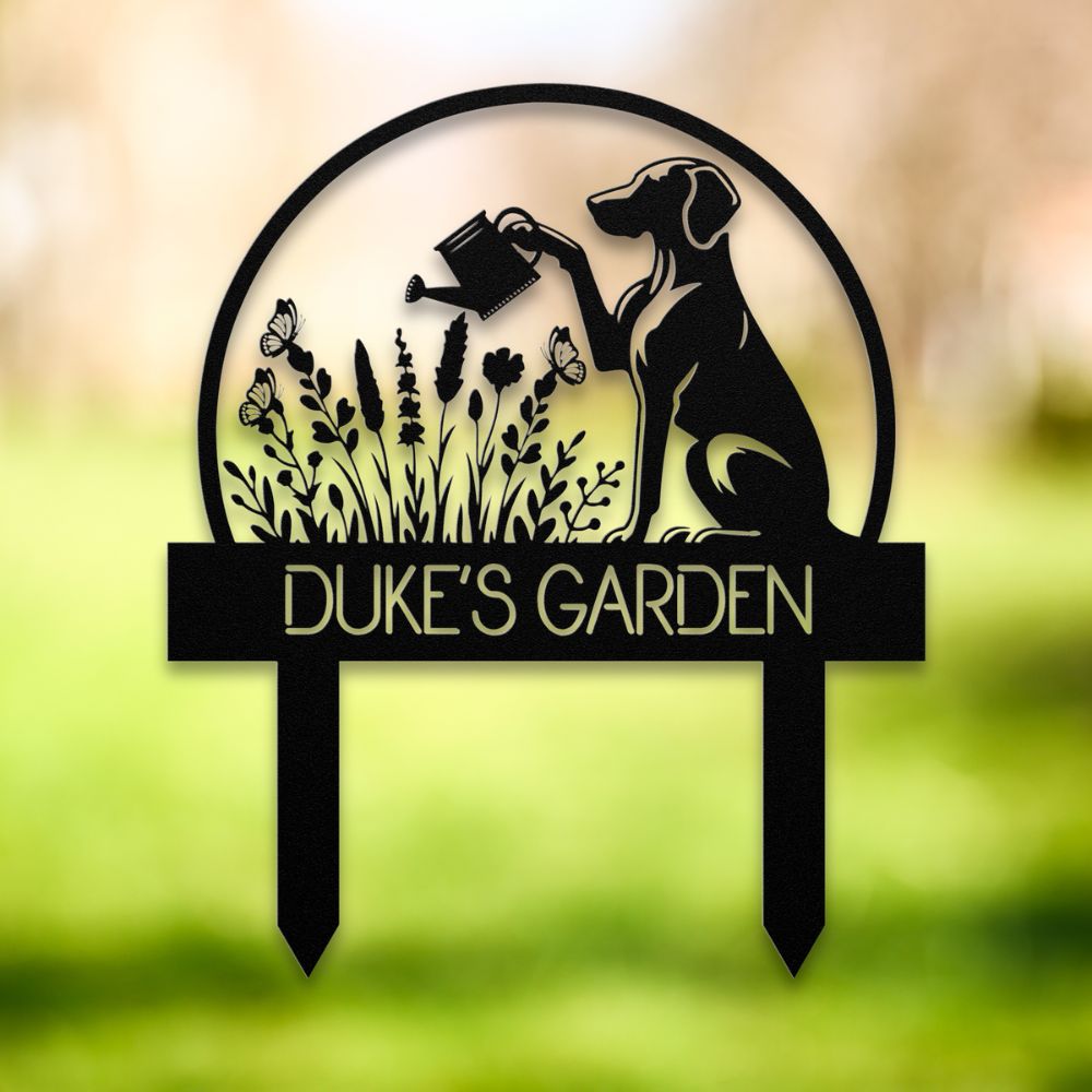 Personalized metal garden stake with dog silhouette holding a watering can, surrounded by flowers and butterflies. Custom “DUKE'S GARDEN” name sign – ideal gift for dog owners and unique outdoor yard decoration.
