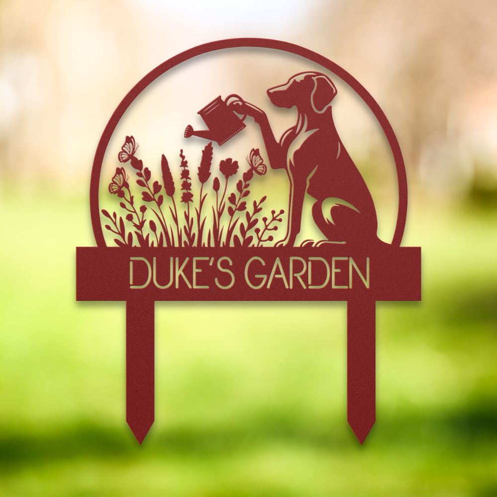 Personalized metal garden stake with dog silhouette holding a watering can, surrounded by flowers and butterflies. Custom “DUKE'S GARDEN” name sign – ideal gift for dog owners and unique outdoor yard decoration.