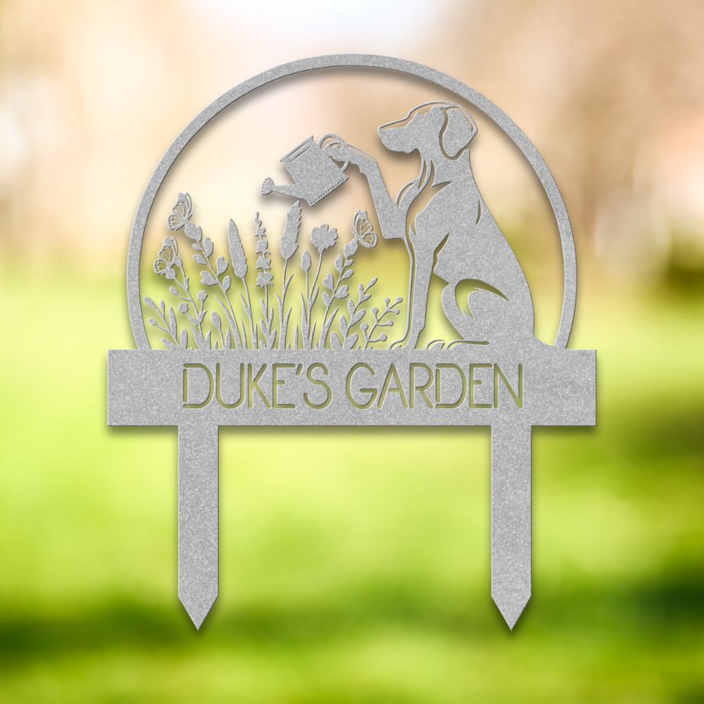 Personalized metal garden stake with dog silhouette holding a watering can, surrounded by flowers and butterflies. Custom “DUKE'S GARDEN” name sign – ideal gift for dog owners and unique outdoor yard decoration.