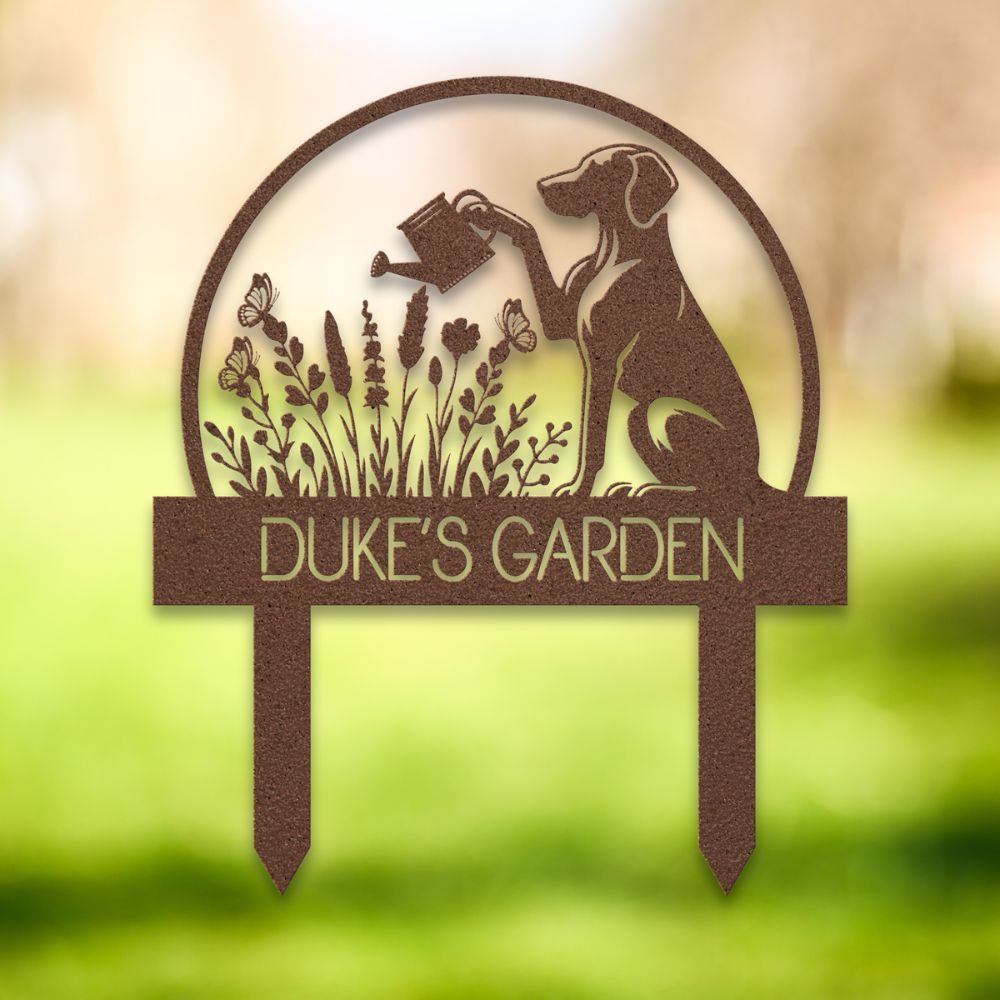 Personalized metal garden stake with dog silhouette holding a watering can, surrounded by flowers and butterflies. Custom “DUKE'S GARDEN” name sign – ideal gift for dog owners and unique outdoor yard decoration.